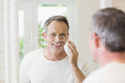 Handsome man applying shaving foam