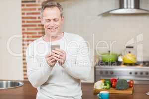 Handsome man looking at smartphone