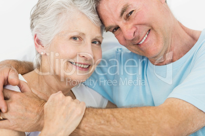 Senior couple face to face smiling at the camera