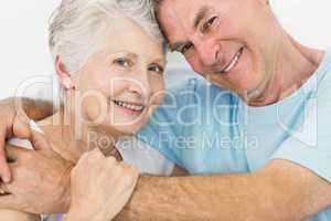 Senior couple face to face smiling at the camera