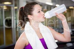 Fit woman drinking water from bottle