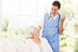 Nurse taking care of sick elderly woman