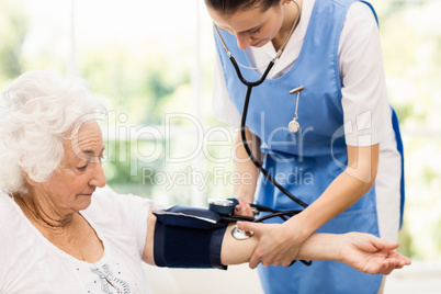 Nurse taking care of sick elderly woman