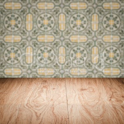 Wood table top and blur vintage ceramic tile pattern wall