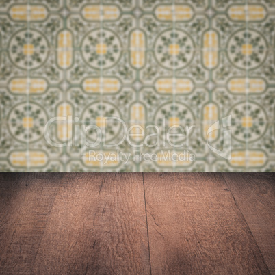 Wood table top and blur vintage ceramic tile pattern wall