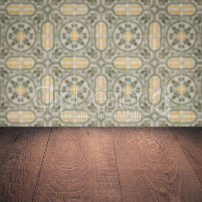 Wood table top and blur vintage ceramic tile pattern wall