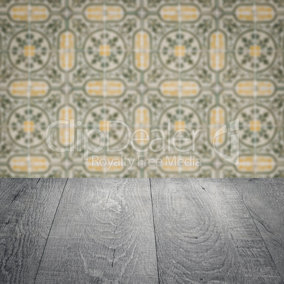 Wood table top and blur vintage ceramic tile pattern wall