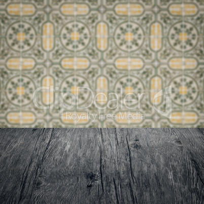 Wood table top and blur vintage ceramic tile pattern wall