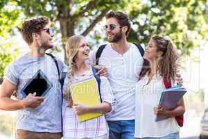 Hip friends holding notebooks and tablet