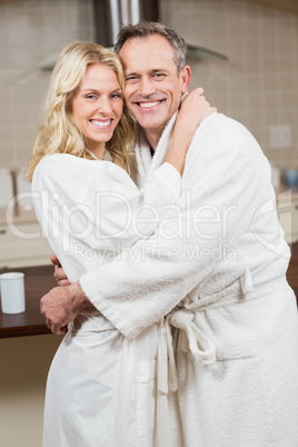 Cute couple hugging in bathrobes