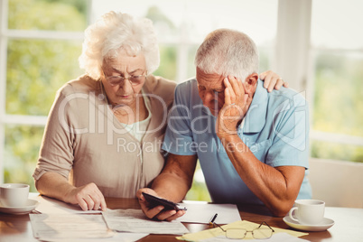 Senior couple counting bills