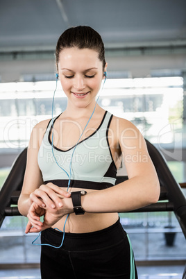 Smiling woman looking at smartwatch