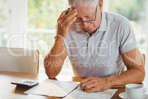 Worried senior man with tax documents