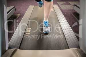 Feet of woman running on treadmill