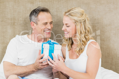Woman offering present to husband