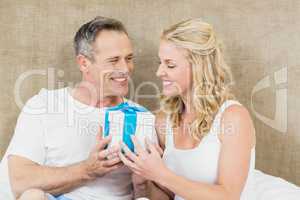 Woman offering present to husband