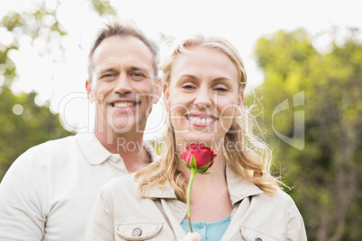 Cute couple holding a rose