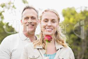 Cute couple holding a rose