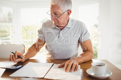 Worried senior man with tax documents