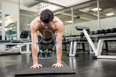 Shirtless man doing push up