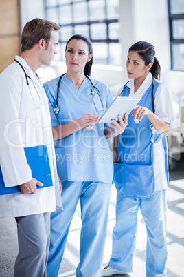 Medical team looking at tablet pc