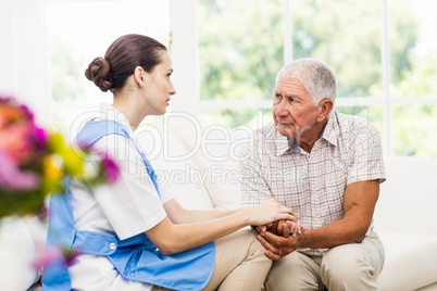 Nurse taking care of sick elderly patient