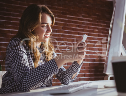 Young hipster businesswoman using her phone