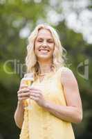 Happy woman drinking glass of champagne