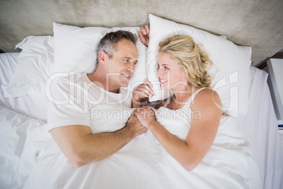 Cute couple cuddling in bed