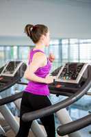 Fit brunette running on treadmill