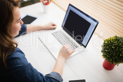 Hipster businesswoman using her laptop