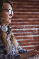 Focused hipster businesswoman with headphone