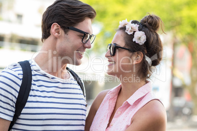 Hip couple smiling to each other