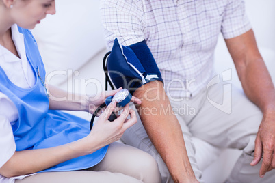 Nurse taking care of sick elderly patient