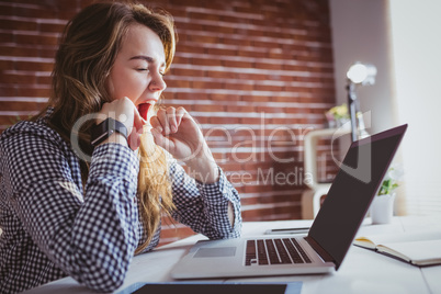 Young hipster businesswoman yawning