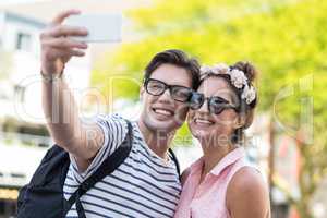 Hip couple taking selfie