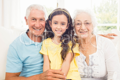 Grandparents smiling with their granddaughter