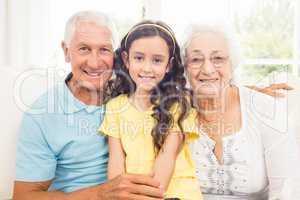 Grandparents smiling with their granddaughter