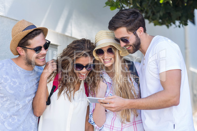 Hip friends looking at smartphone