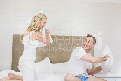 Cute couple playing pillow fight