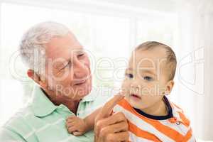 Senior man playing with his grandson