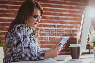 Focused hipster businessman using tablet