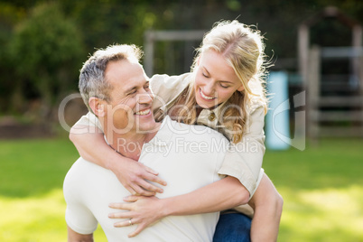 Husband giving piggy back to wife