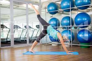 Fit blonde doing yoga on mat