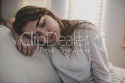 Tired woman falling asleep on the couch