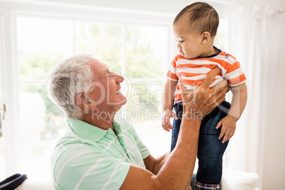 Senior man playing with his grandson