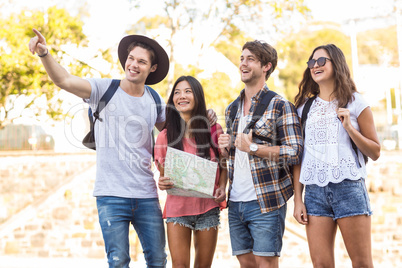 Hip friends going on a walk and checking map