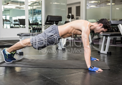 Shirtless man doing push up