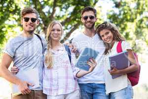 Hip friends holding tablet and notebooks