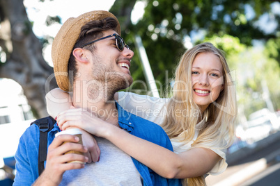 Hip couple embracing and smiling